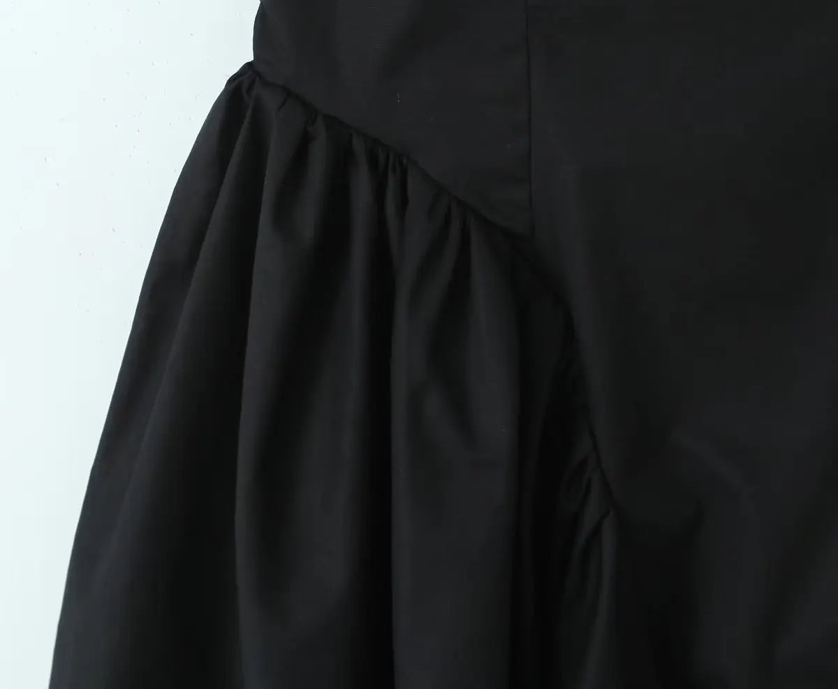 Black::Close-up of a black skirt on a white background