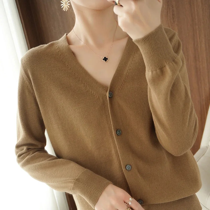 allvariants:: Brown cardigan worn by a person with a blurred background