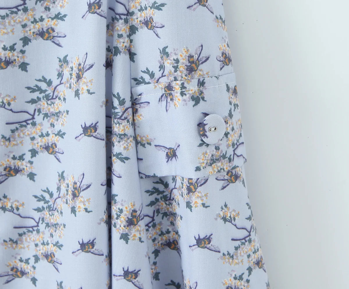 Light blue:: fabric with floral and insect pattern on a white background