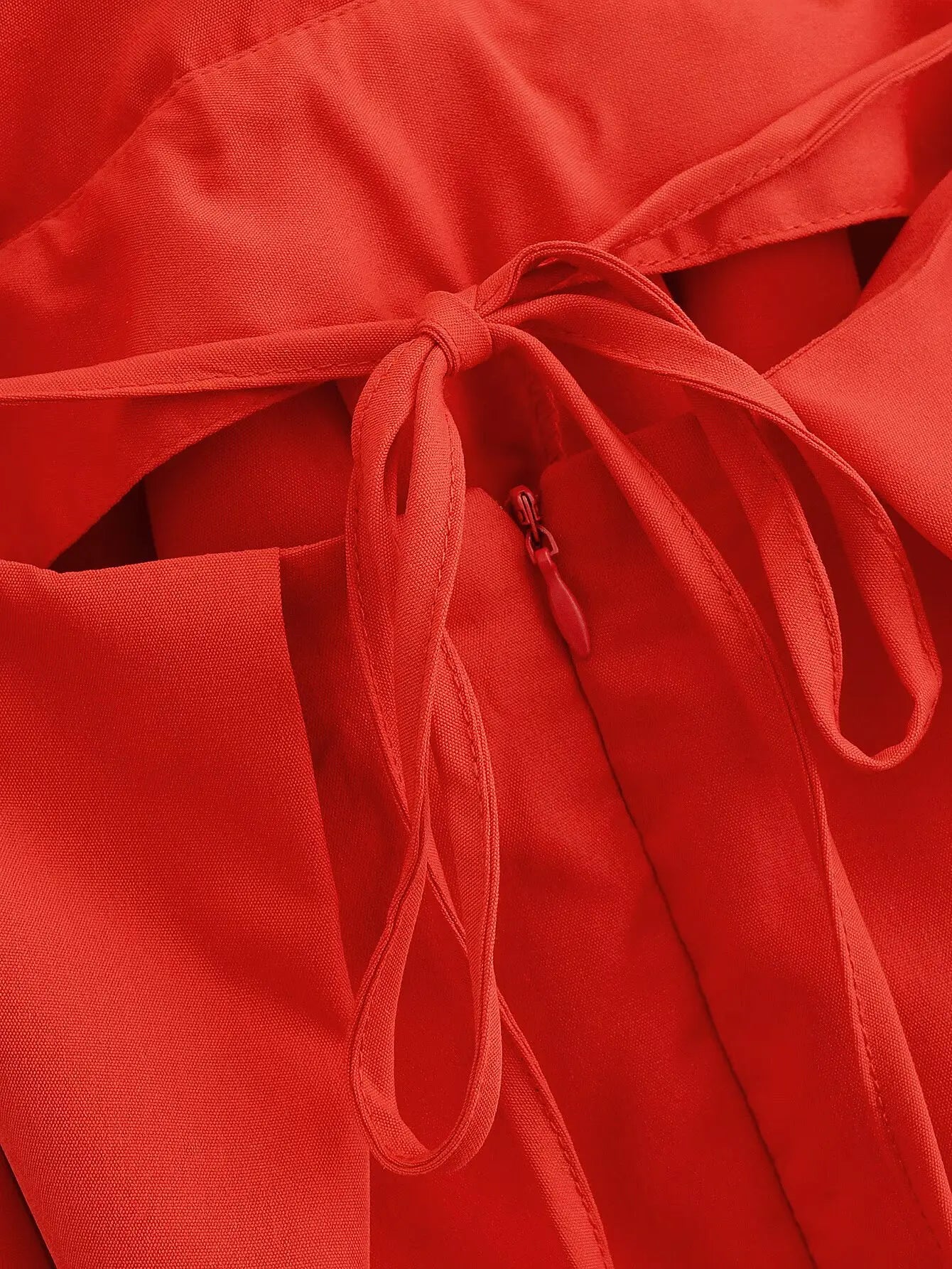 red::Close-up of a red garment with a tie detail