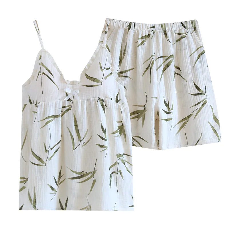allvariants:: Set of white top and shorts with green leaf pattern on a white background