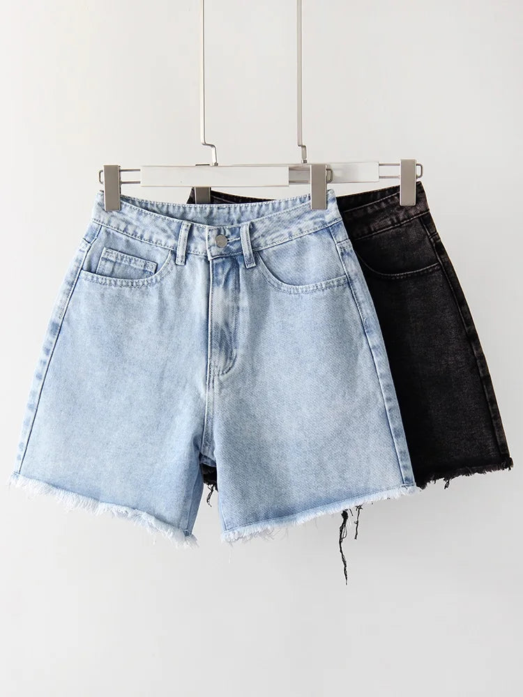 allvariants:: Two pairs of denim shorts, one light blue and one black, hanging on a rack against a white background.