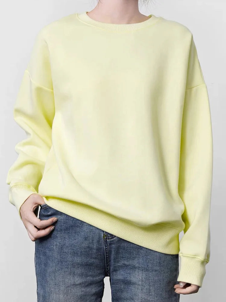 allvariants:: Person wearing a light yellow sweater and blue jeans on a plain background