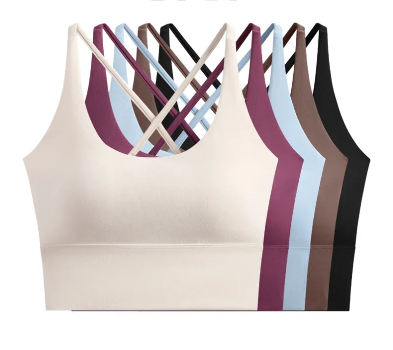 allvariants:: Beige sports bra with criss-cross design and color options displayed on a white background