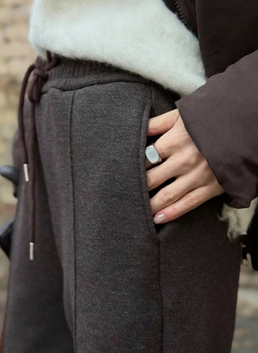Person wearing a brown coat with a blurred background