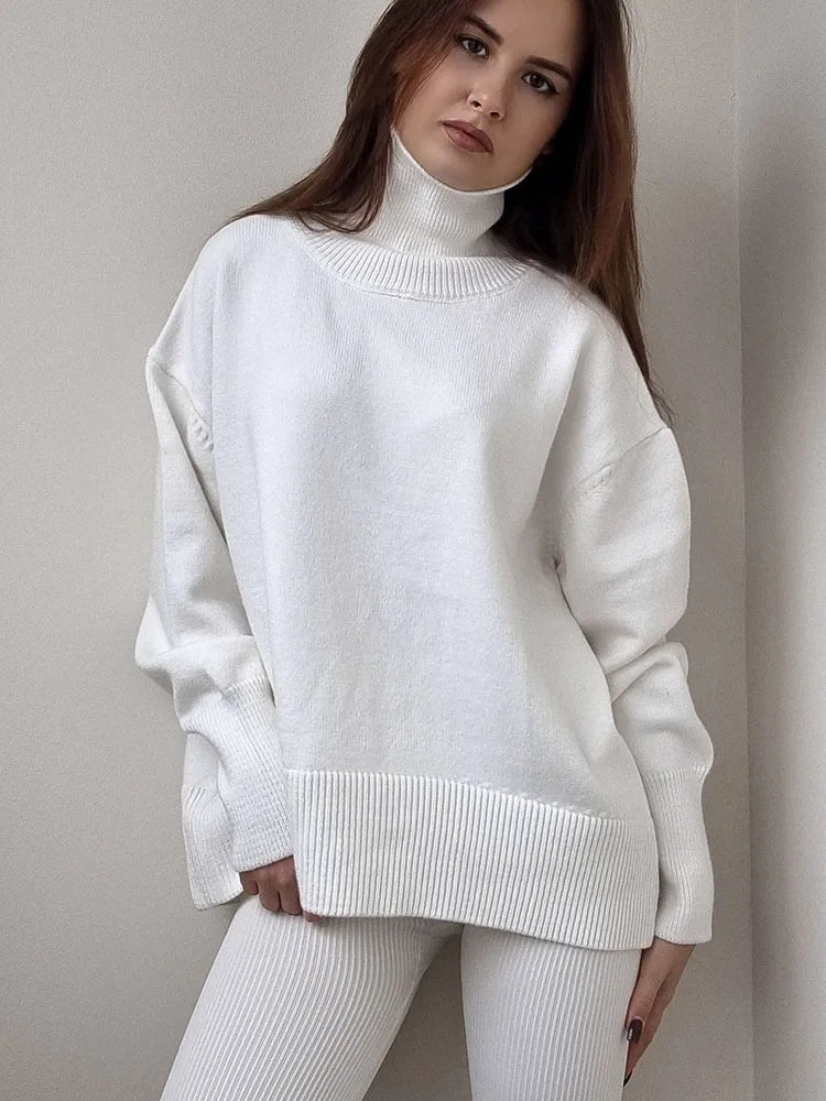 allvariants:: Woman wearing a white sweater and pants against a plain background