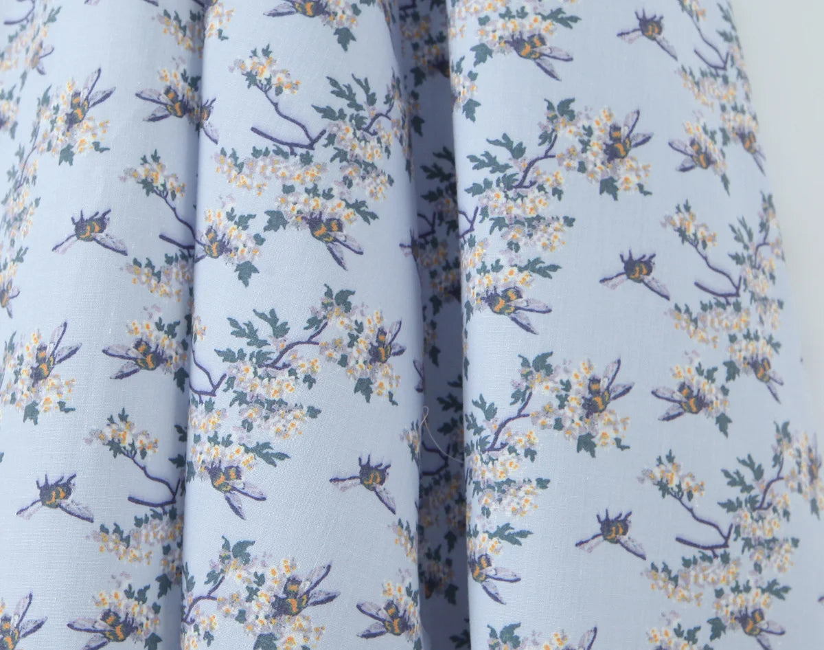 light blue::Close-up of fabric with floral pattern on a light blue background