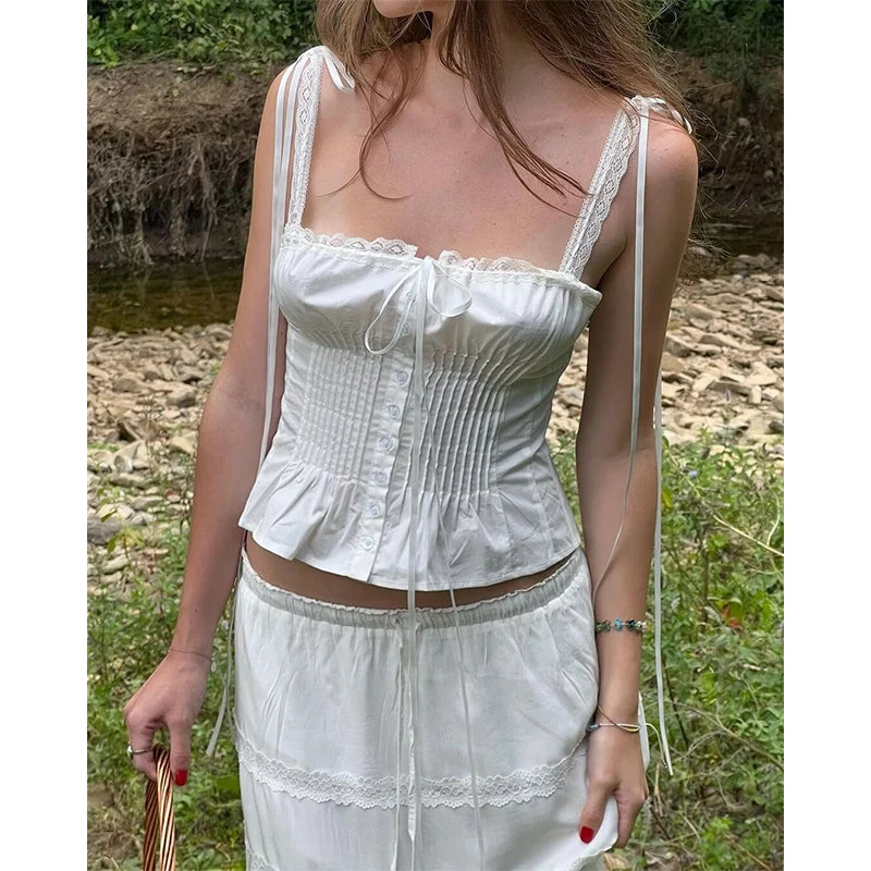 white::Woman wearing a white lace top and skirt outdoors by a stream