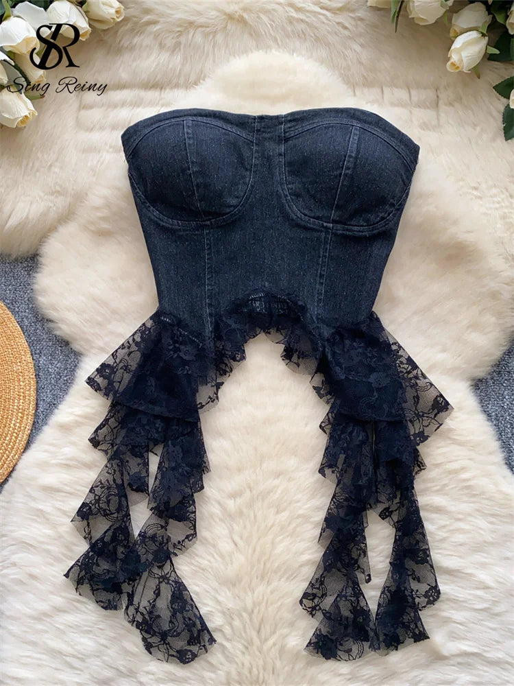 Denim-style top with lace details on a textured surface